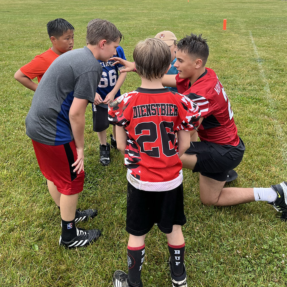Campers listening to a Lancaster Football Player